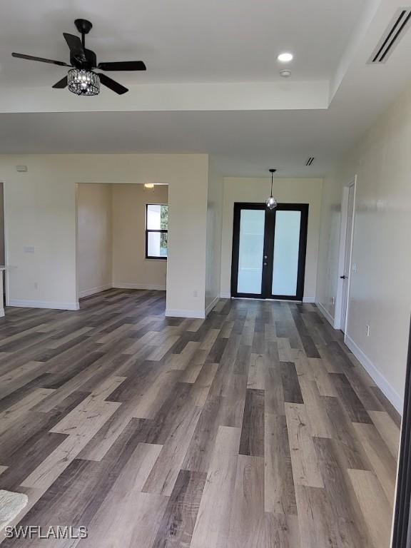 empty room with french doors, hardwood / wood-style flooring, and ceiling fan