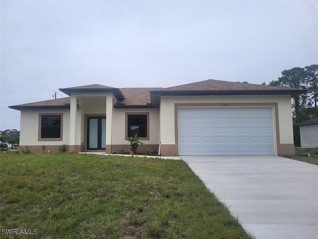 view of front of home featuring a garage and a front lawn