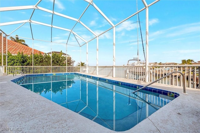 view of pool with glass enclosure