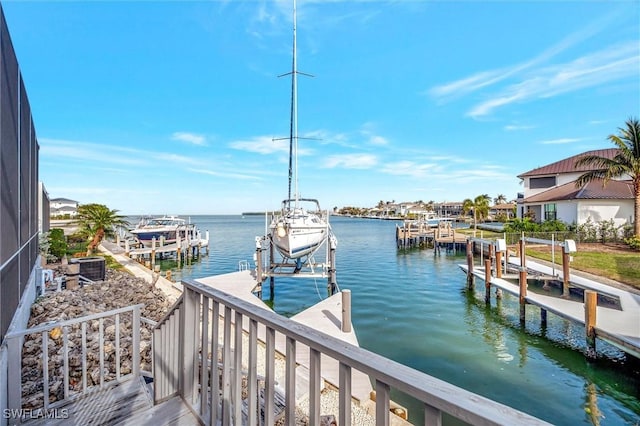 view of dock featuring a water view, glass enclosure, and central AC unit