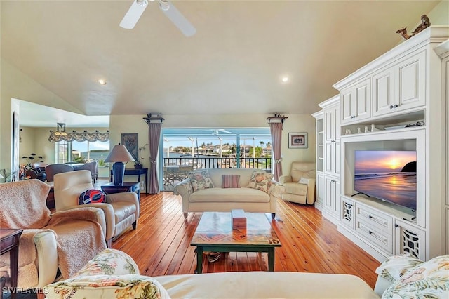 living room featuring ceiling fan, lofted ceiling, a healthy amount of sunlight, and light wood-type flooring