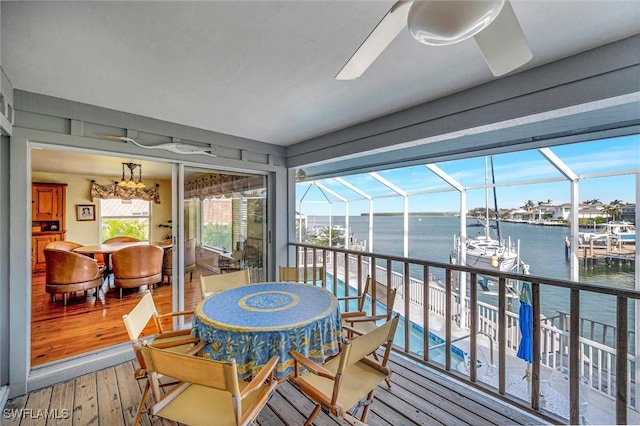 sunroom / solarium featuring a water view