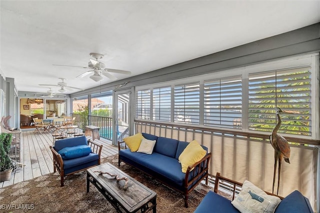 sunroom featuring ceiling fan