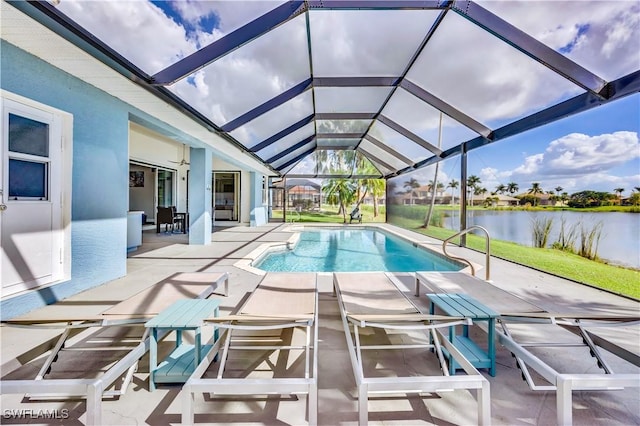 view of pool with a lanai, a patio area, ceiling fan, and a water view