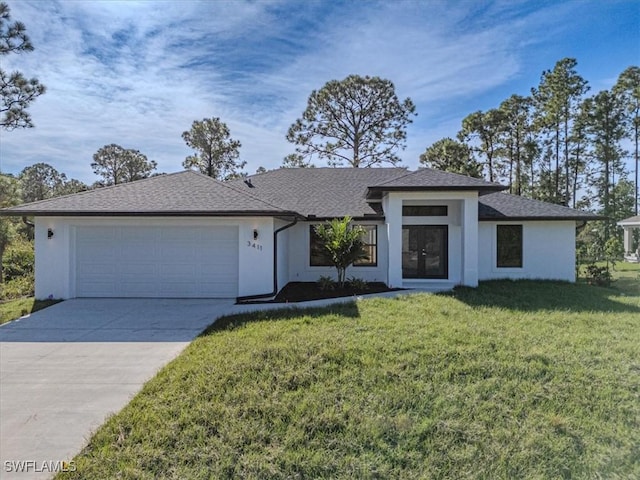 view of front of home with a front yard and a garage