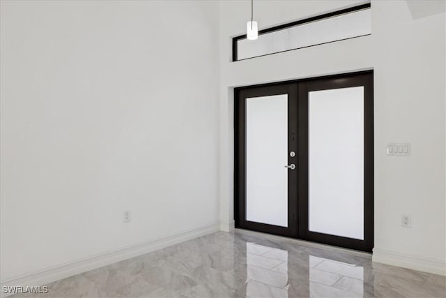 spare room with french doors and a wealth of natural light