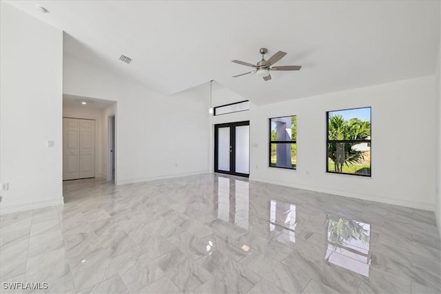 spare room featuring french doors, vaulted ceiling, and ceiling fan