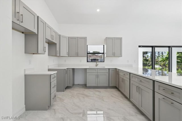 kitchen featuring gray cabinetry, sink, and a healthy amount of sunlight