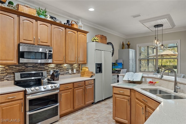 kitchen featuring decorative light fixtures, ornamental molding, sink, and appliances with stainless steel finishes