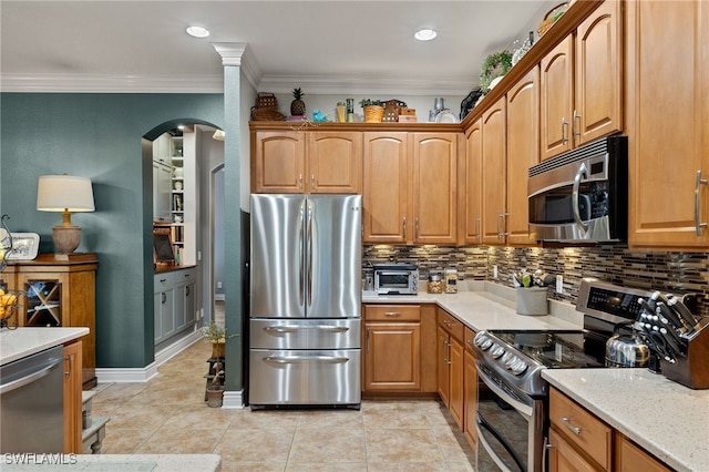 kitchen featuring light tile patterned floors, backsplash, stainless steel appliances, and crown molding