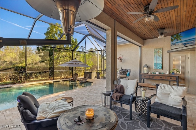 view of patio / terrace featuring glass enclosure and ceiling fan