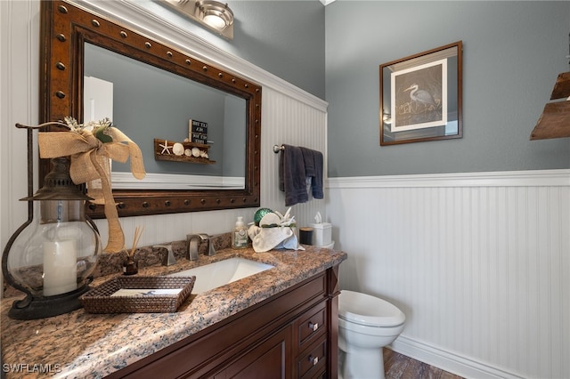 bathroom featuring hardwood / wood-style floors, vanity, and toilet