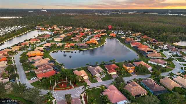 aerial view at dusk with a water view