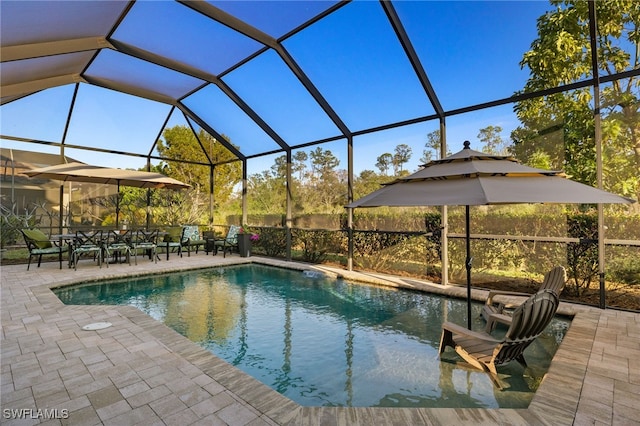 view of swimming pool with a lanai and a patio