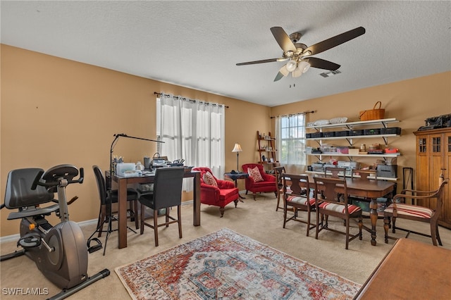 interior space featuring a textured ceiling and ceiling fan