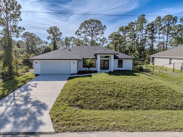 view of front of house featuring a front yard and a garage