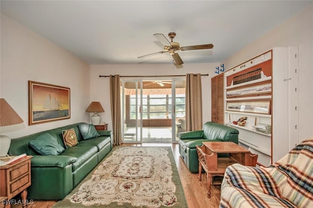 living room with ceiling fan and light hardwood / wood-style floors