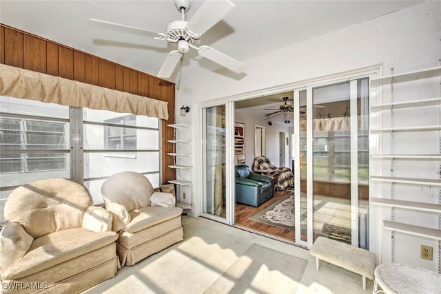 sunroom / solarium featuring ceiling fan