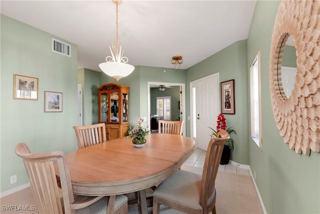 carpeted dining area featuring ceiling fan