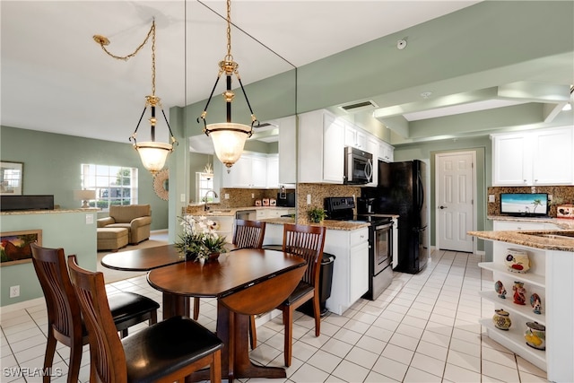 kitchen with light stone counters, white cabinetry, pendant lighting, and appliances with stainless steel finishes