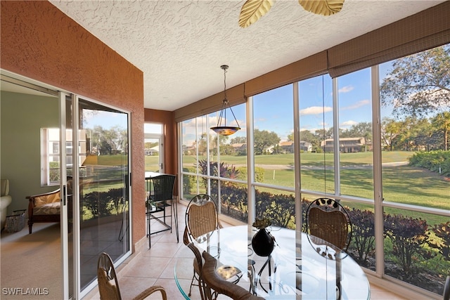 sunroom / solarium featuring ceiling fan