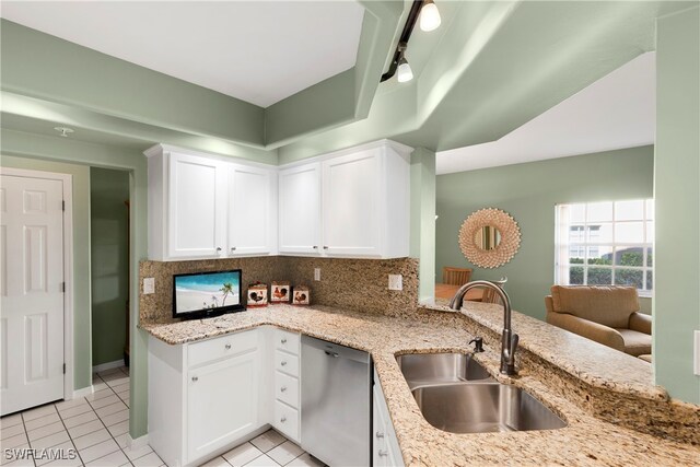 kitchen with rail lighting, sink, white cabinetry, and dishwasher