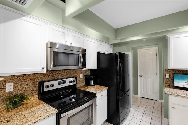 kitchen featuring light tile patterned flooring, white cabinets, and stainless steel appliances