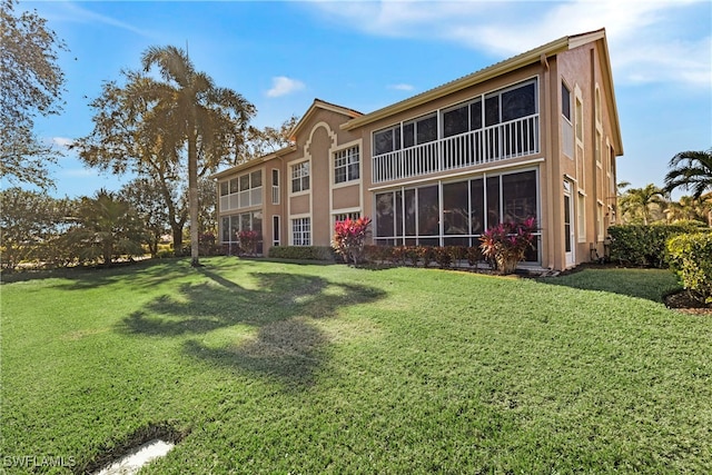 rear view of property with a lawn