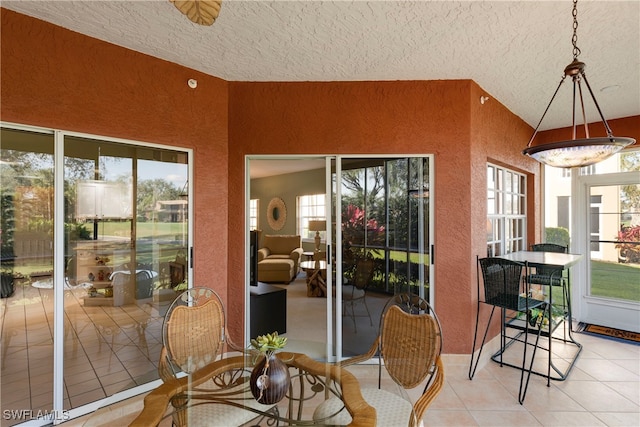 sunroom / solarium with plenty of natural light and lofted ceiling