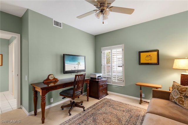 tiled office space featuring ceiling fan