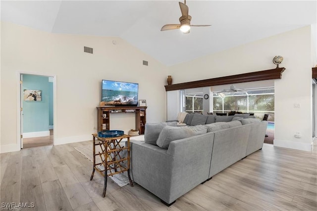 living room featuring ceiling fan, light hardwood / wood-style flooring, and high vaulted ceiling