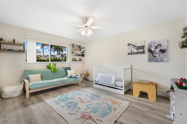 sitting room featuring ceiling fan and light hardwood / wood-style floors