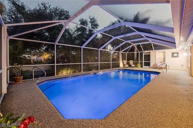 view of pool featuring glass enclosure and a patio