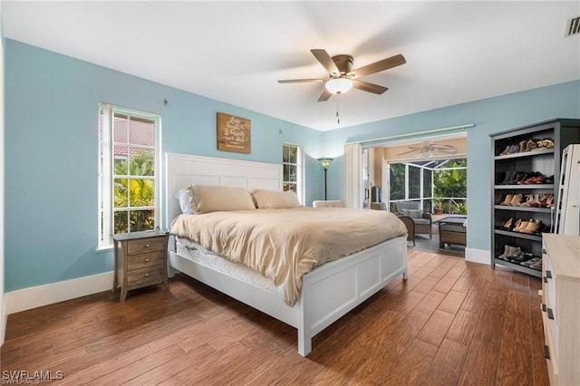 bedroom with dark hardwood / wood-style flooring and ceiling fan