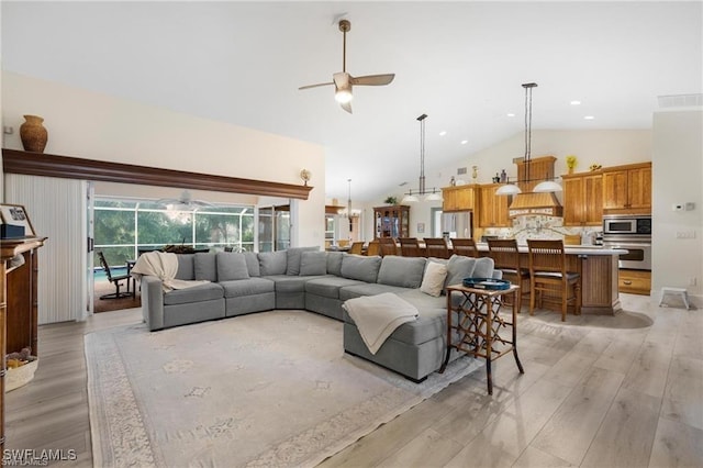 living room with high vaulted ceiling, light hardwood / wood-style flooring, and ceiling fan