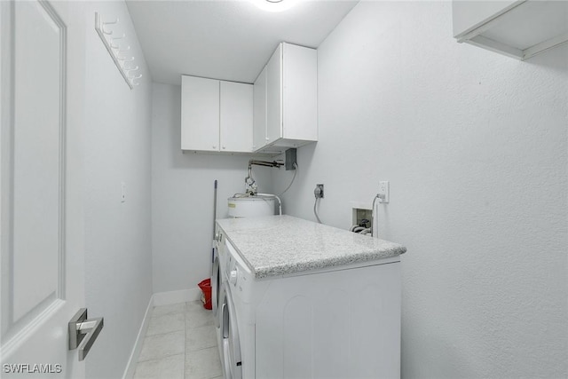 washroom with cabinets and washer / dryer