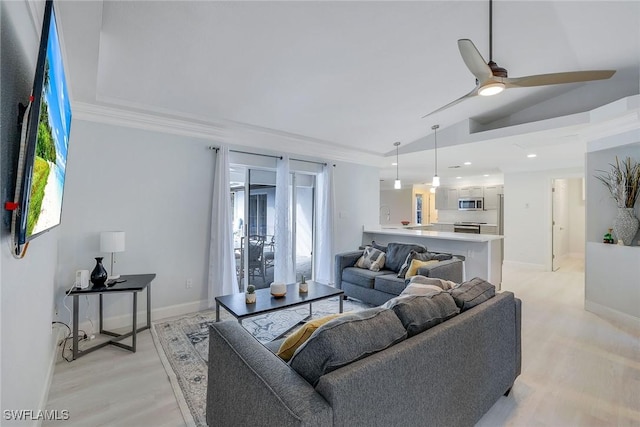 living room featuring ceiling fan, light hardwood / wood-style floors, and lofted ceiling