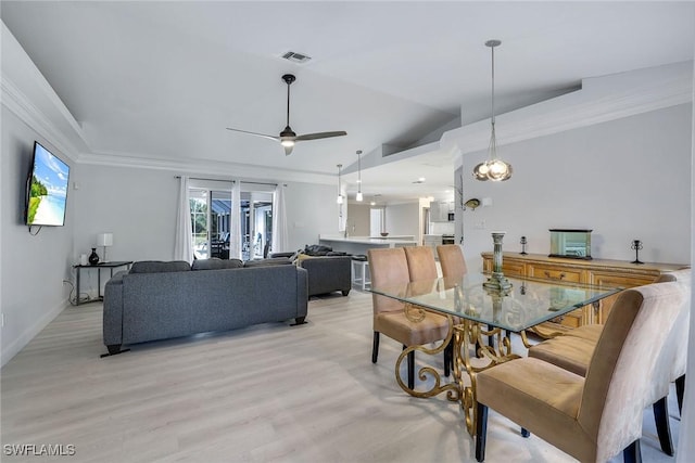 dining room featuring french doors, ornamental molding, vaulted ceiling, ceiling fan, and light hardwood / wood-style flooring