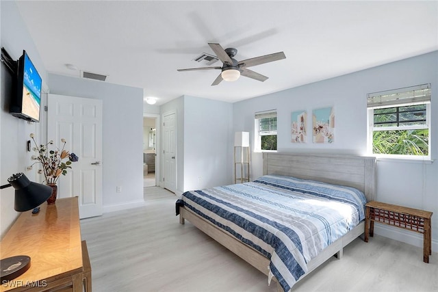 bedroom featuring ceiling fan, ensuite bathroom, and light hardwood / wood-style flooring