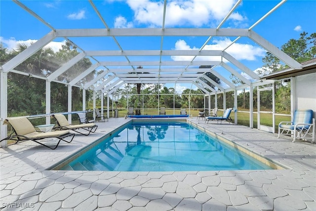 view of swimming pool featuring a lanai and a patio area