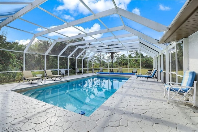 view of swimming pool featuring a patio area and a lanai