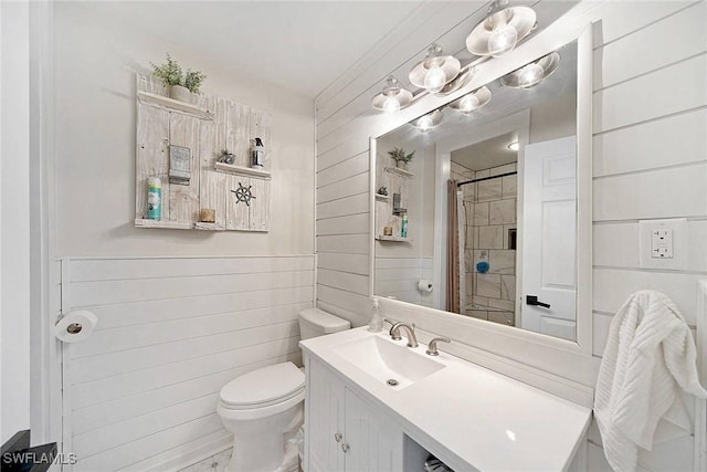 bathroom with toilet, vanity, and a shower with shower curtain