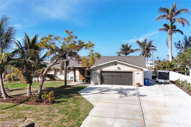 view of front of home with a front lawn and a garage