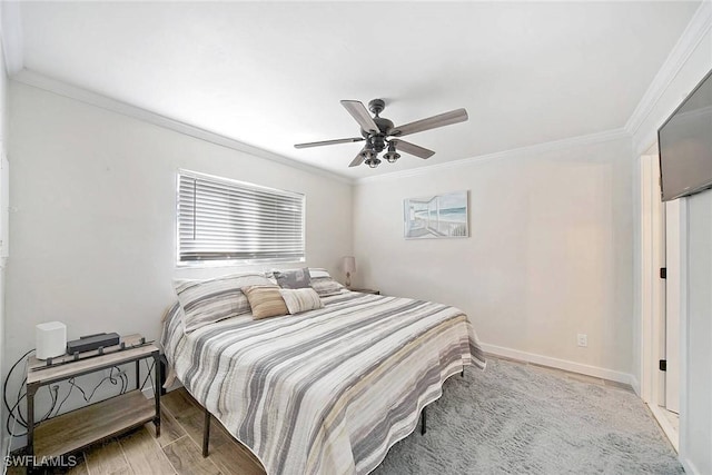 bedroom with light wood-type flooring, ceiling fan, and ornamental molding