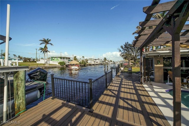 dock area featuring a pergola and a water view