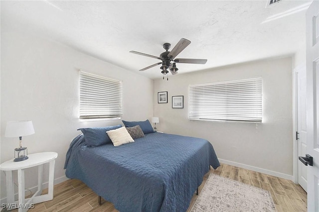 bedroom featuring ceiling fan and light hardwood / wood-style flooring