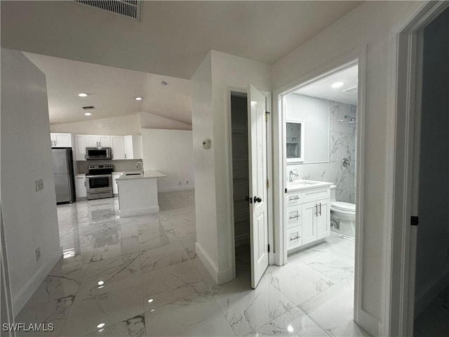 hall with sink and lofted ceiling