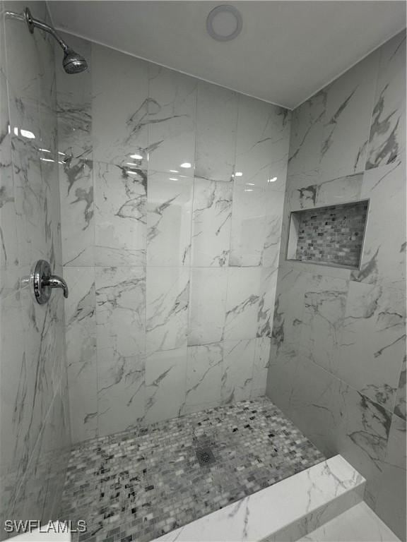 bathroom with a tile shower