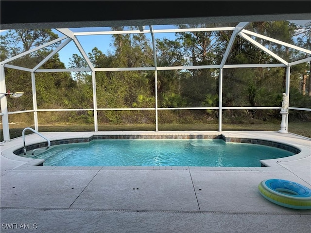 view of pool with glass enclosure