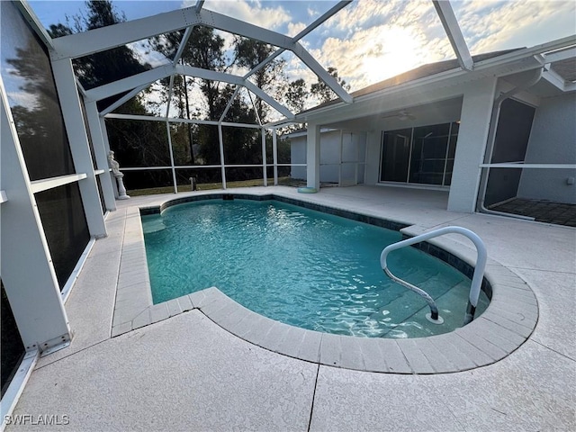 view of swimming pool featuring a lanai, ceiling fan, and a patio